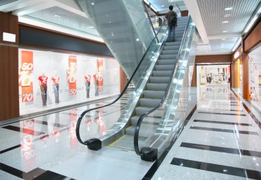 Persons on escalator in shop clipart