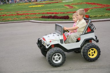 Boy and girl in toy car clipart