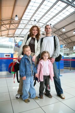 Standing traveling family of four clipart