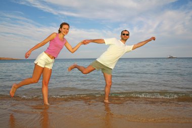 Running couple on beach clipart