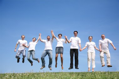 Group of friends in white T-shorts jump together clipart