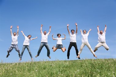 Seven friends in white T-shorts joyfully jump together clipart