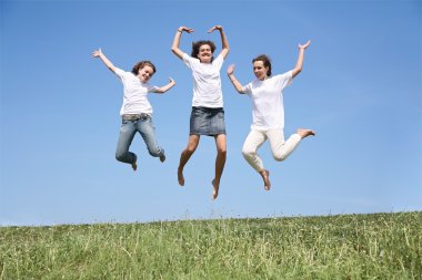 Three girlfriends in white T-shorts jump simultaneously clipart