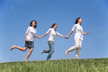 Three girlfriends in white T-shorts together run clipart