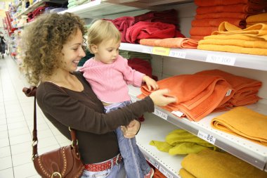 Mother with baby in shop clipart