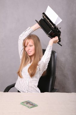 Girl in the irritation throws the typewriter clipart