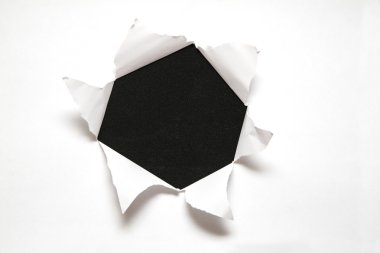 The sheet of paper with the hole against the black background clipart