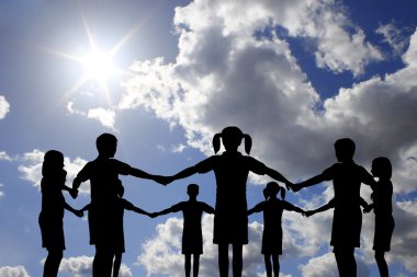 Children circle on real sunny sky clipart