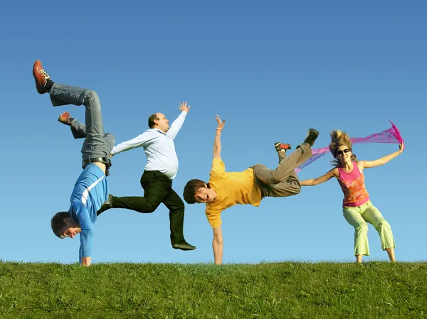 Many jumping on the grass, collage — Stock Photo, Image