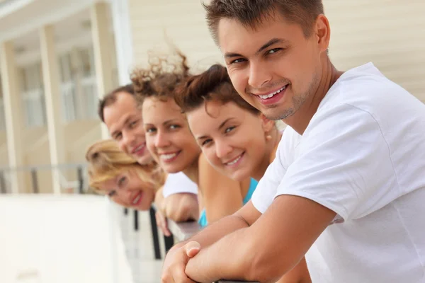 Five smiling friends on balcony — Stock Photo, Image