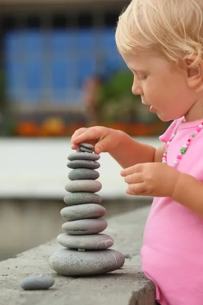 Meisje hoed is een bouw van pebble stenen — Stockfoto