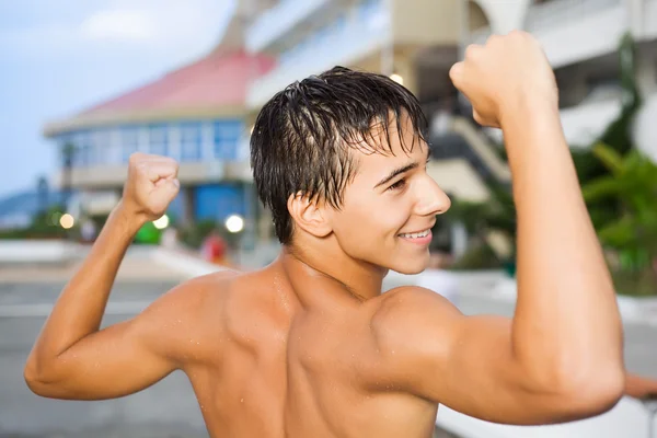 Teenager boy standing near hotel on resort in evening, teenager — Stock Photo, Image
