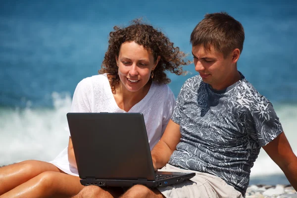 남자와 여자 노트북으로 해변에 — 스톡 사진