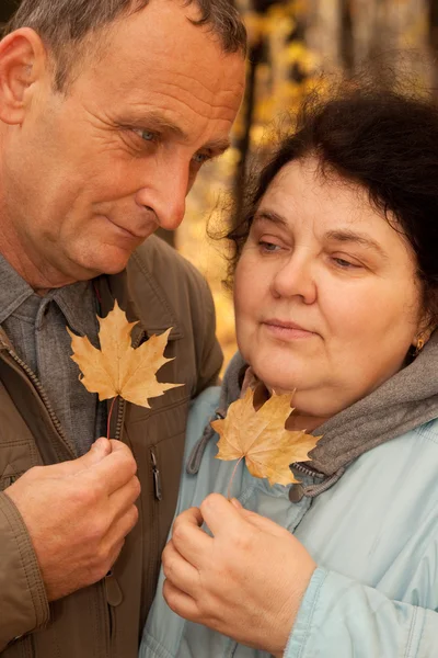 Old man and old woman in autumnal forest — Stock Photo, Image