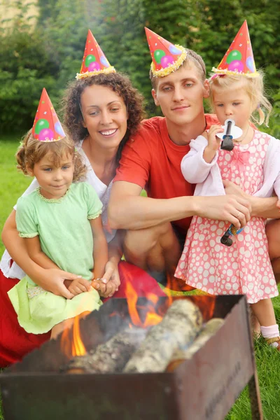 Happy family with children near brazier on picnic, happy birthda — Stock Photo, Image