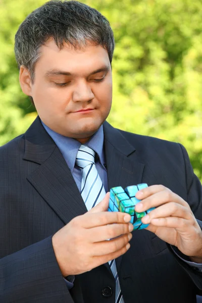 Uomo d'affari tiene in mano cubo all'aperto in estate — Foto Stock