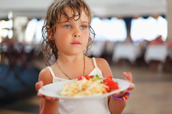 Little pretty girl with dishes in hands at restaurant — Stock Photo, Image