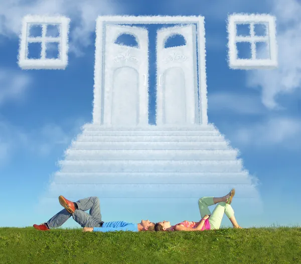 Lying couple on grass and dream door way collage — Stock Photo, Image