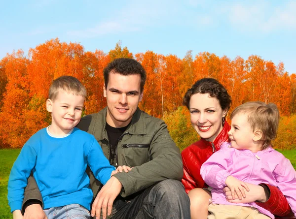 Family of four in autumnal park collage — Stock Photo, Image