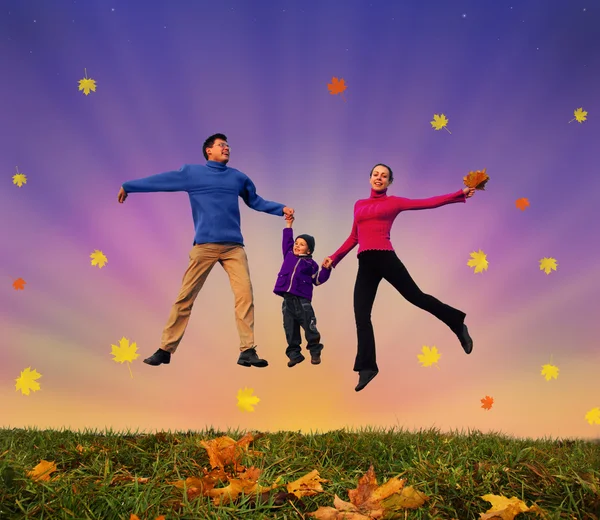 Jumping family with boy on autumnal meadow collage — Stock Photo, Image