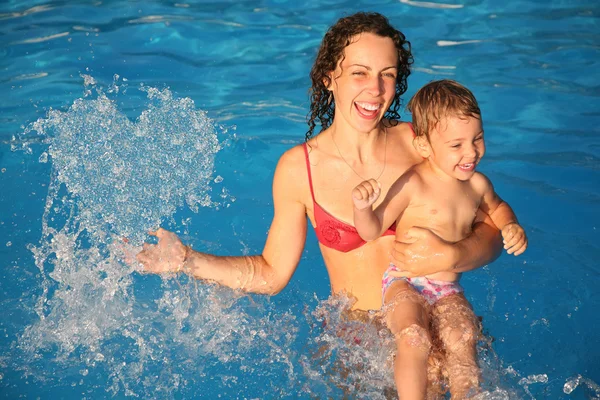 Mother in water with child makes heart with drops, collage — Stock Photo, Image