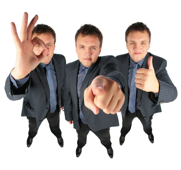 Tři podnikatelé, dva ok gestem a jedno zobrazující vám, c — Stock fotografie