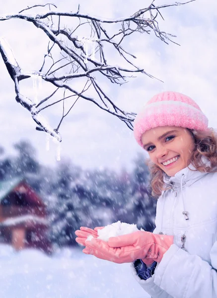 Young beauty girl outdoor in winter holds snow in hands — Stock Photo, Image