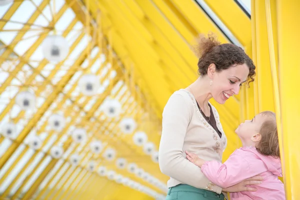 Mother with baby on yellow bridge — Stock Photo, Image