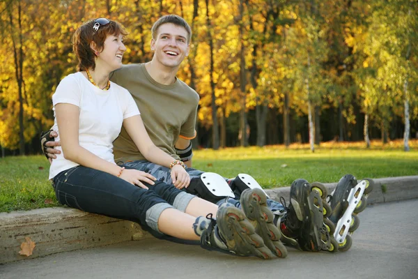 Young roller couple sit — Stock Photo, Image