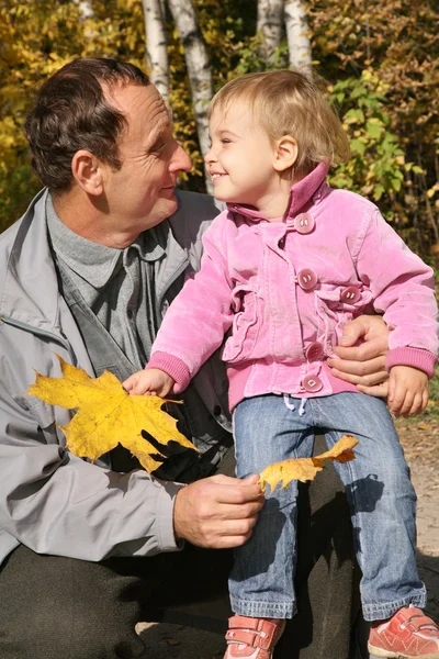 Grandfather with the granddaughter in the park in autumn 3 — Stock Photo, Image