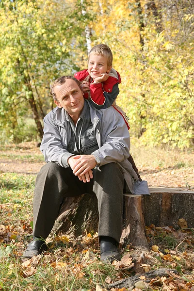 Grandfather with child in autumn park — Stock Photo, Image