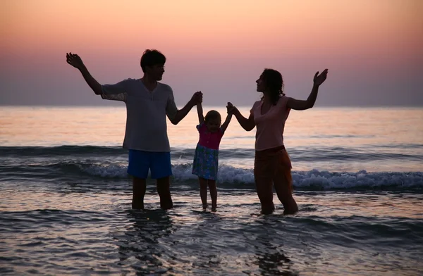 Family in sea on sunset — Stock Photo, Image