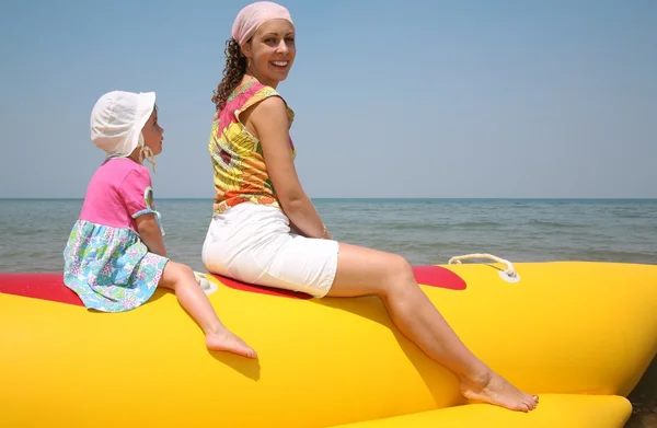 Mother with the daughter they sit on the inflatable boat — Stock Photo, Image