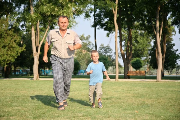 stock image Grandfather with grandson run