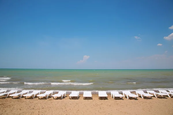Chaise lounges on the shore of the sea — Stock Photo, Image