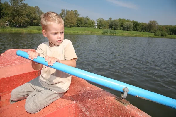 Boy in the boat with the oar — Stock Photo, Image