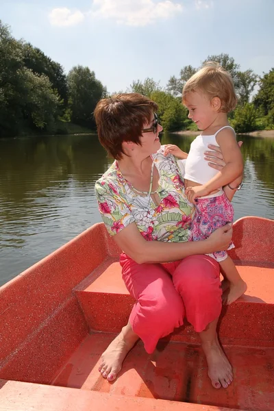 Woman with the girl in the boat — Stock Photo, Image