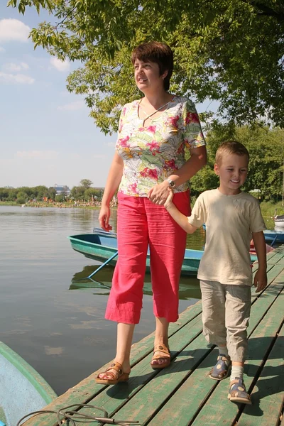 Woman with the boy on the moorage — Stock Photo, Image