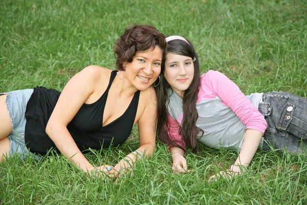 Mother and daughter-teenager lie on the grass 3 — Stock Photo, Image