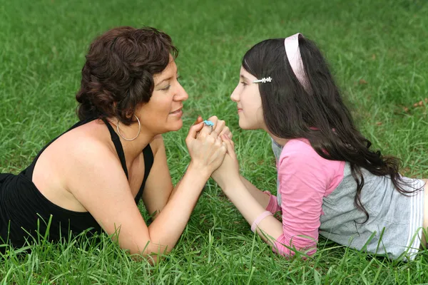 Mother with teenager on grass lie — Stock Photo, Image
