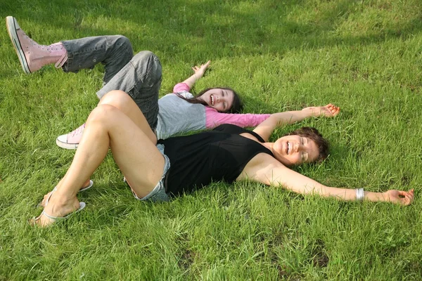 Женщина с подростком на траве — стоковое фото