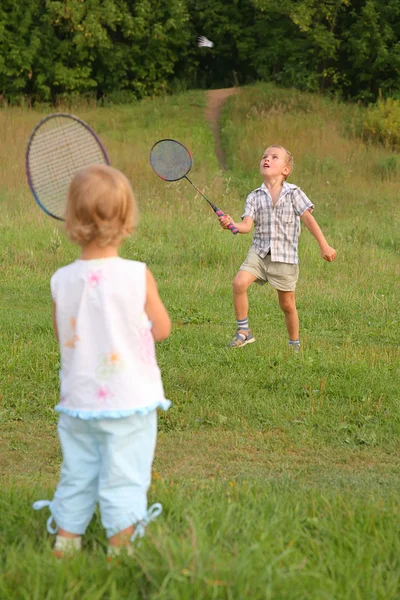 Ragazzo e ragazza giocare badminton — Foto Stock