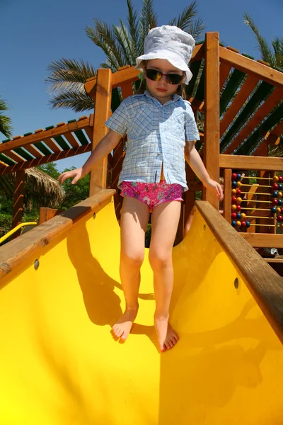 Tropical girl on slide — Stock Photo, Image
