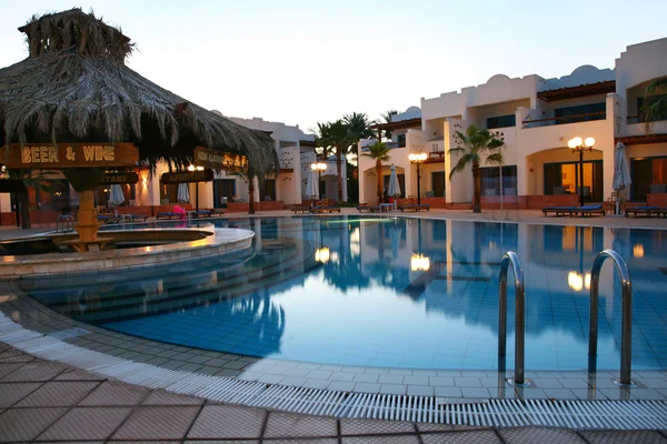 Večerní shot z bazénu v tropický hotel — Stock fotografie