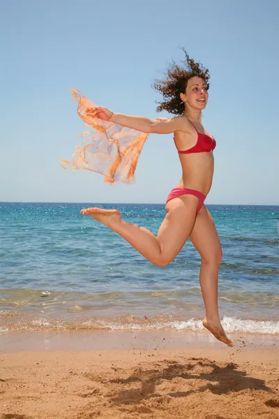 The woman in a jump at the sea — Stock Photo, Image