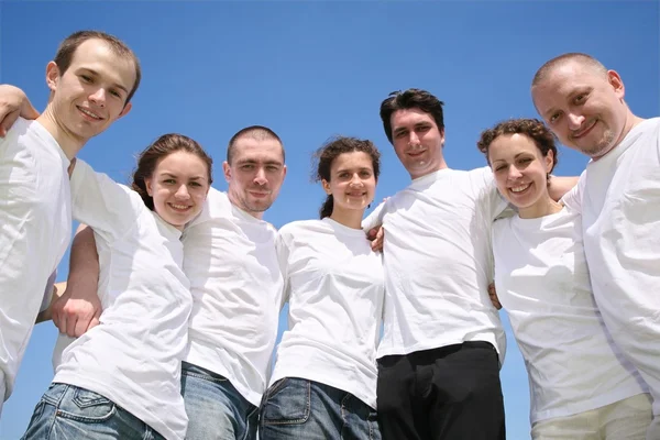 Group of friends in white T-shorts are in a circle — Stock Photo, Image