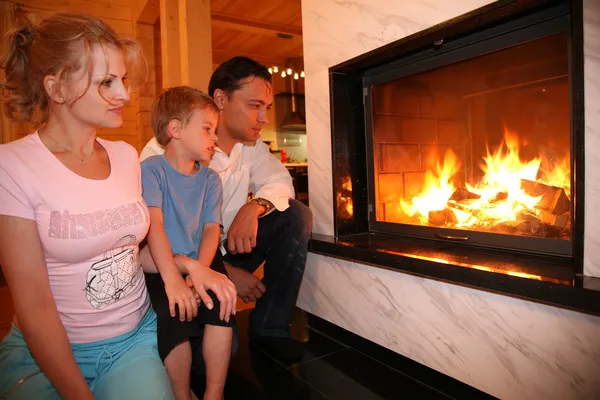 Family and fireplace — Stock Photo, Image