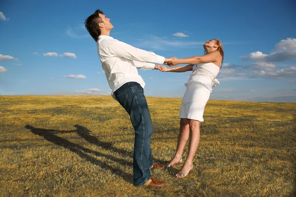 Man and woman hold each other for the hands — Stock Photo, Image