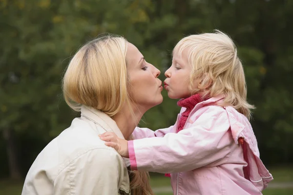 Dívka a matka polibek — Stock fotografie