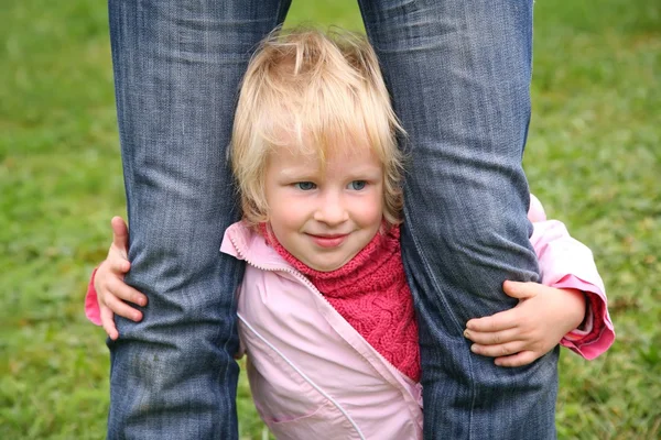Filha fica de pé e ele é mantido para os pés em jeans — Fotografia de Stock